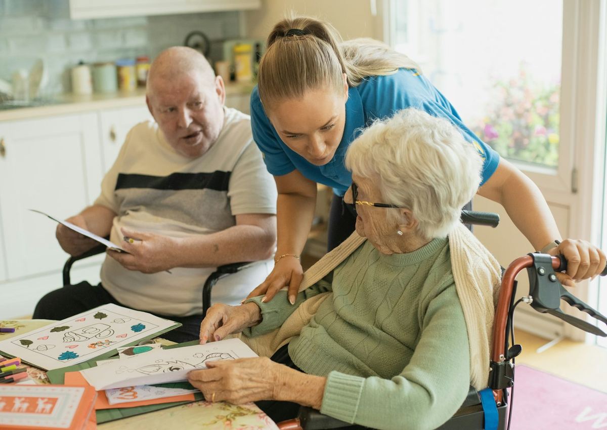 A caregiver and an older couple enjoying an afternoon together